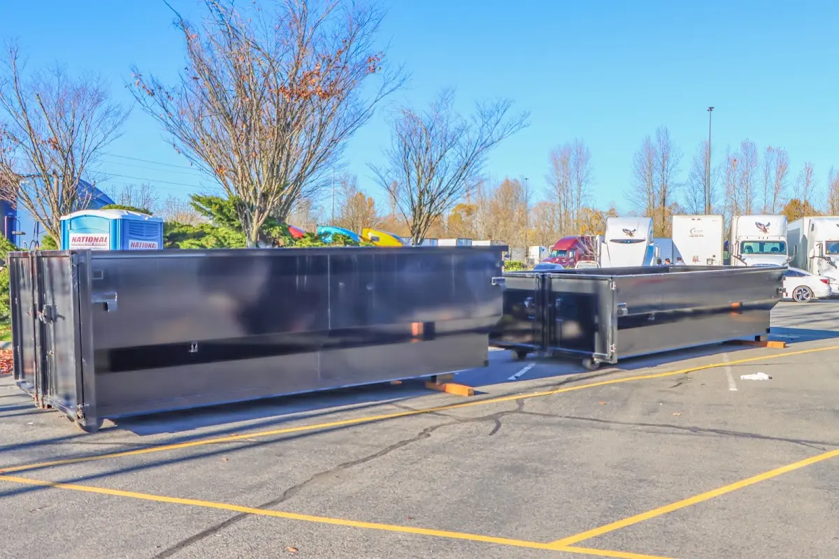 Professional dumpster rental service with roll-off container on residential driveway in Horseheads